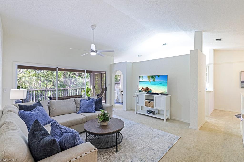 386 Emerald Bay Circle, Unit G4 Naples, FL 34110 - Photo 2 of 22 a living room with furniture and a flat screen tv