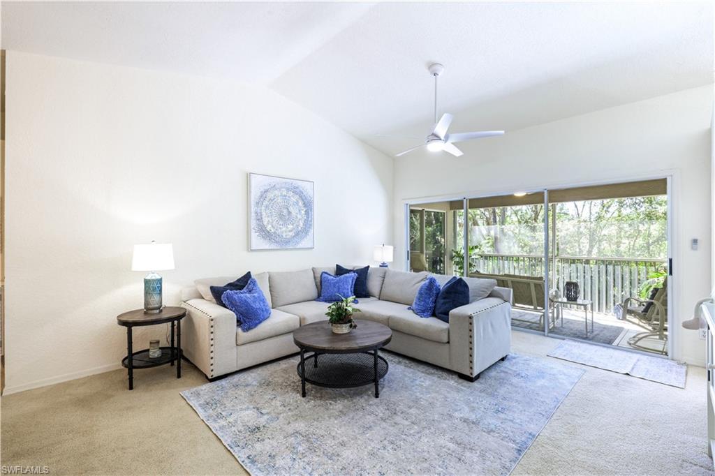 386 Emerald Bay Circle, Unit G4 Naples, FL 34110 - Photo 3 of 22 a living room with furniture and a large window