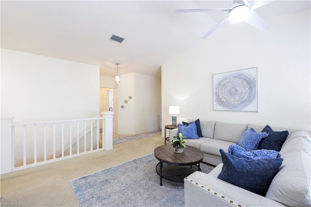 386 Emerald Bay Circle, Unit G4 Naples, FL 34110 - Photo 4 of 22 a living room with furniture and a wooden floor