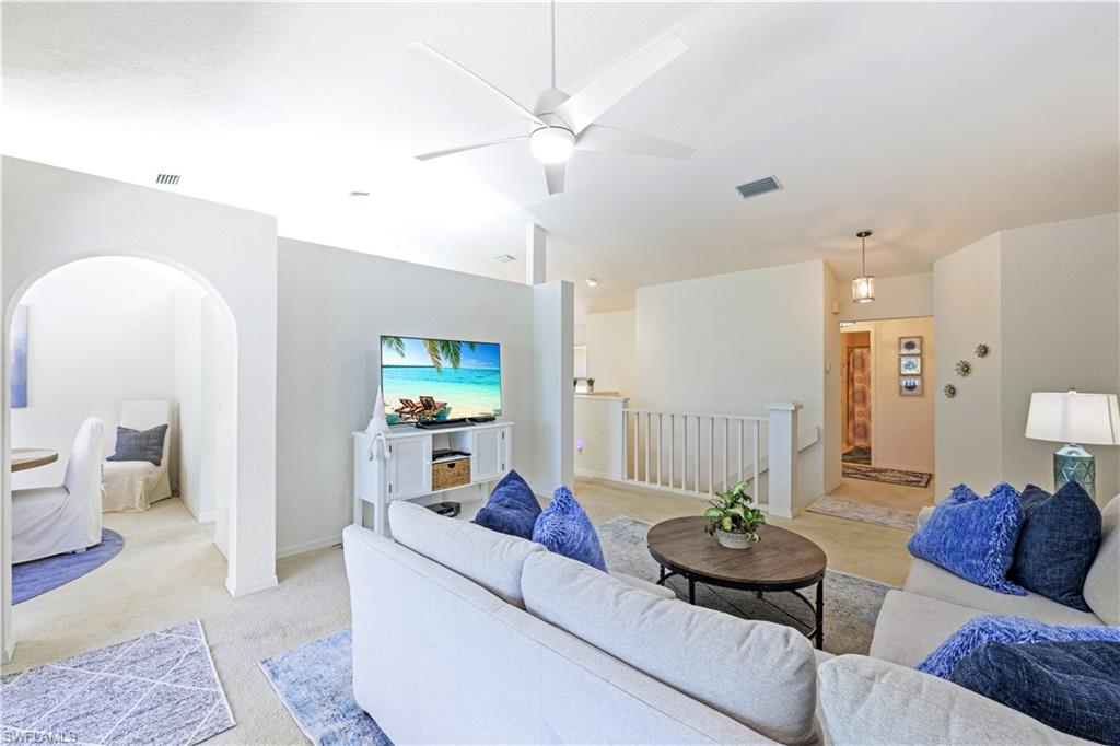 386 Emerald Bay Circle, Unit G4 Naples, FL 34110 - Photo 5 of 22 a living room with furniture and a couch