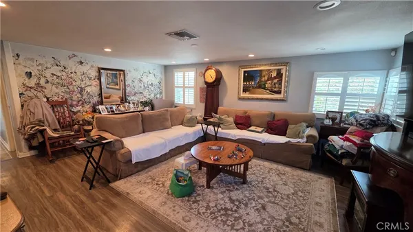 a view of a hallway with wooden floor and glass door