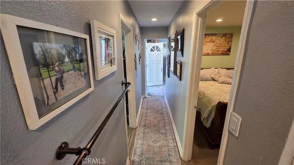 a view of a hallway with furniture