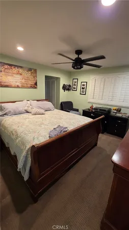 a bed room with furniture and a flat screen tv