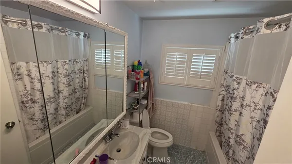 a bathroom with a shower curtain and a toilet