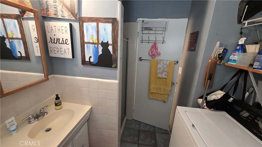 1642 Fourth Street Norco, CA 92860 - Photo 35 of 35 a bathroom with a sink a mirror and shower