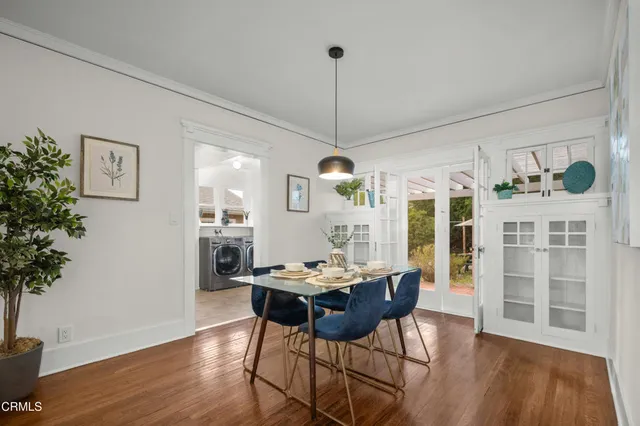 a view of a dining room with furniture window and wooden floor