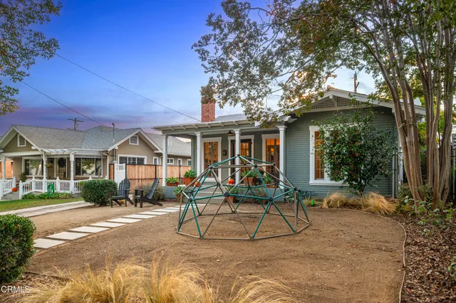 a view of a house with backyard porch and sitting area
