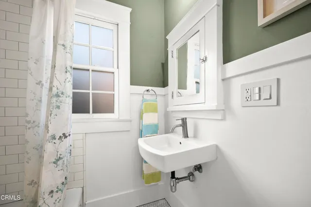 a bathroom with a sink a mirror and shower