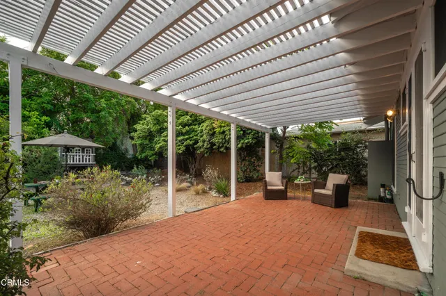 a view of a patio with chairs and plants