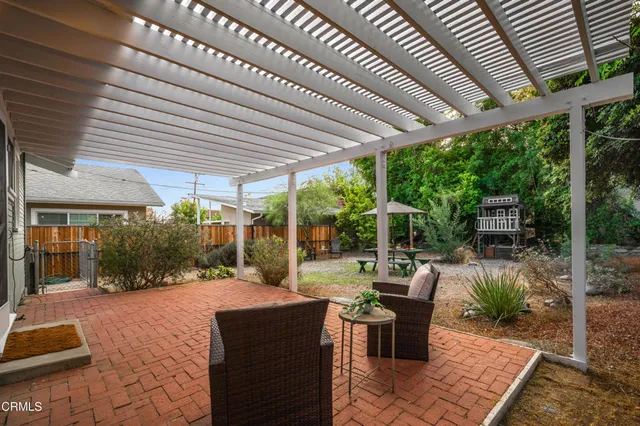 a patio with yard table and chairs