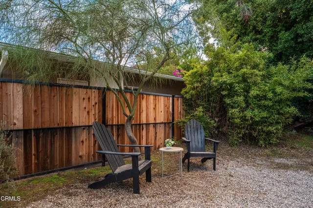 a backyard of a house with table and chairs