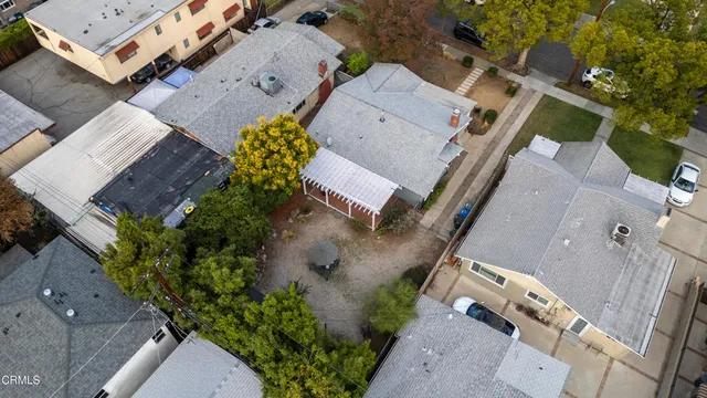 an aerial view of a house with a yard