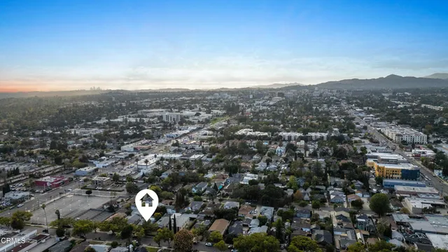 an aerial view of residential houses with city view