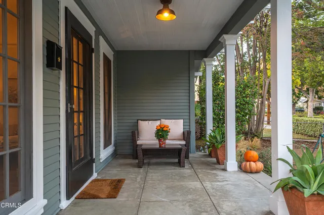 a backyard of a house with barbeque oven table and chairs