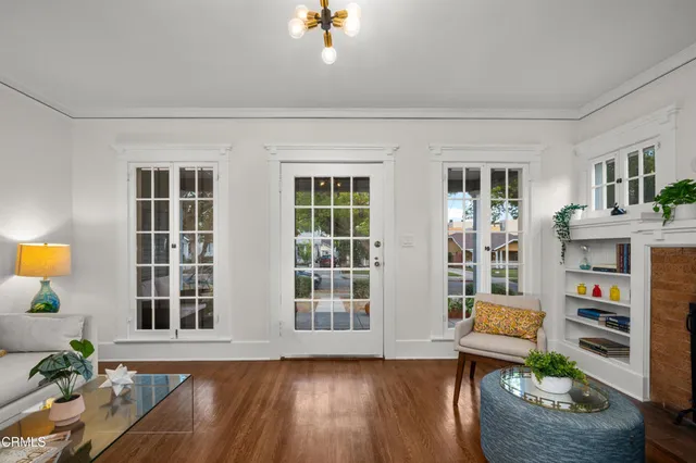 a living room with furniture and a book shelf