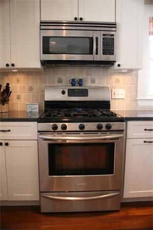 5 Taft Avenue Maynard, MA 01754 - Photo 15 of 26 a stove top oven sitting inside of a kitchen