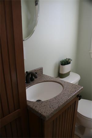 5 Taft Avenue Maynard, MA 01754 - Photo 9 of 26 a bathroom with a granite countertop sink and a toilet