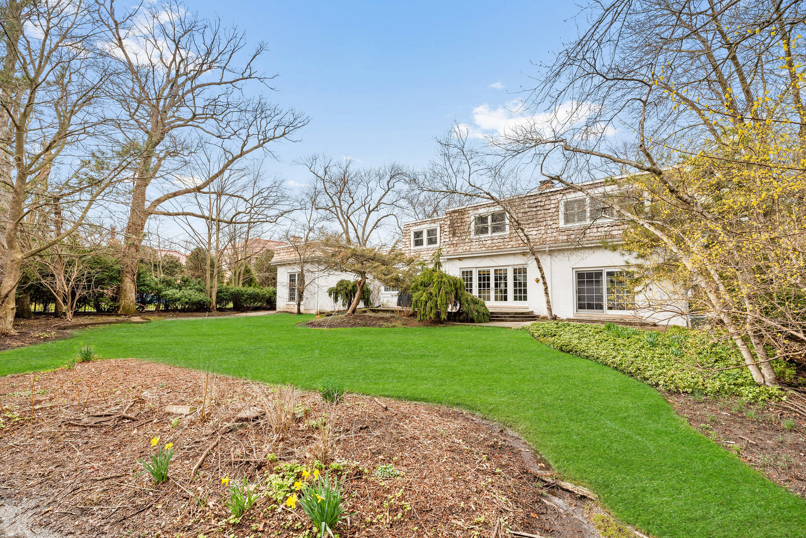 200 Hazel Avenue Glencoe, IL 60022 - Photo 35 of 51 a view of a big house with a big yard and large trees