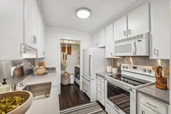 a kitchen with stainless steel appliances a sink stove and refrigerator