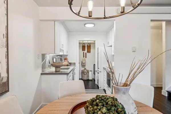 a living room with stainless steel appliances furniture and a rug