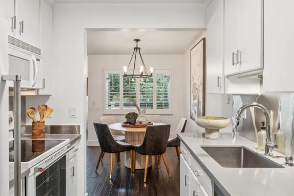 a kitchen with a dining table and chairs