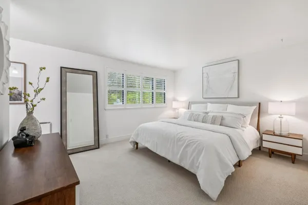 a bedroom with a bed and a night stand