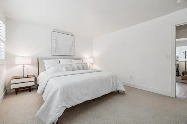 a bedroom with bed and window