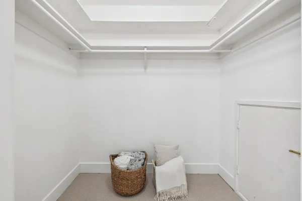 a bathroom with a granite countertop toilet sink and mirror