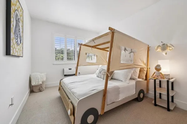 a bedroom with a bed and a window