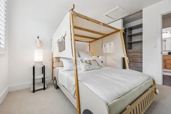 a bedroom with furniture and a window
