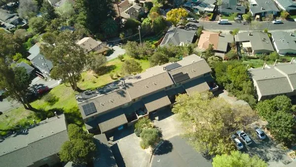 an aerial view of a house with a yard basket ball court and outdoor seating