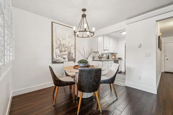 a dining room with furniture window and wooden floor