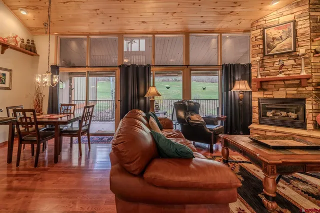 a living room with furniture a fireplace and windows