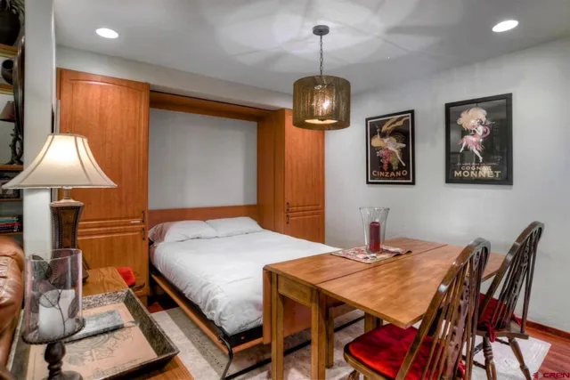 a view of a dining room with furniture wooden floor and chandelier