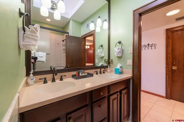a bathroom with a sink vanity and a mirror