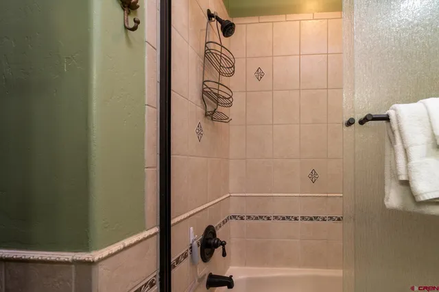 a bathroom with a bathtub and shower