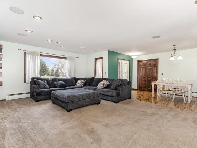 a living room with furniture a large window and a table
