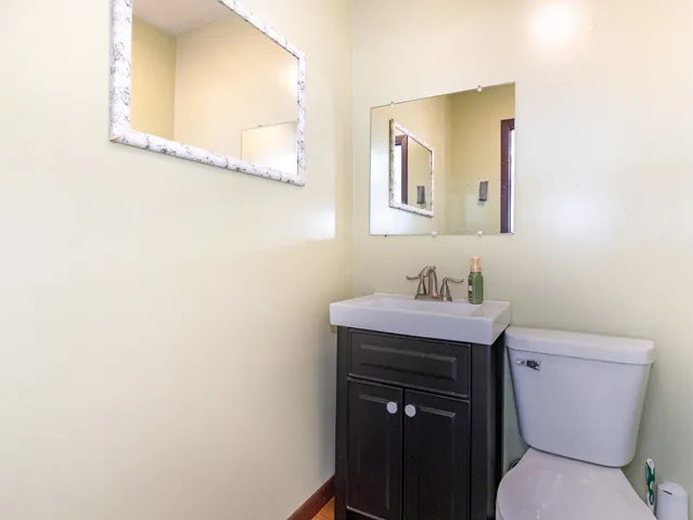a bathroom with a sink a toilet and mirror