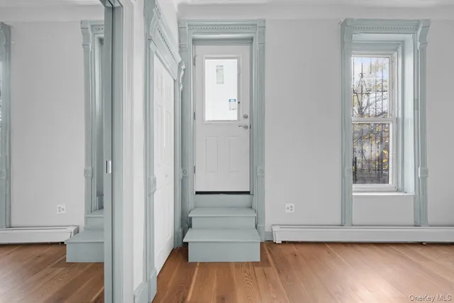 a view of a room with wooden floor and staircase