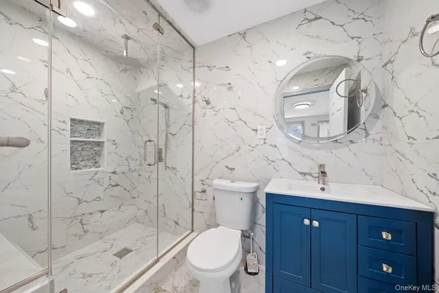 a bathroom with a toilet a sink and shower