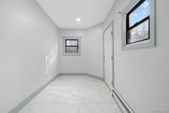 an empty room with windows and closet