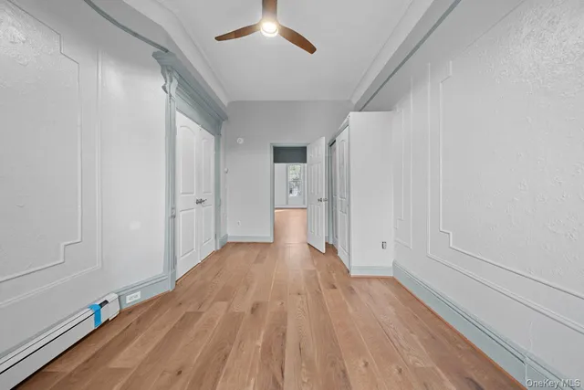 a view of a room with wooden floor and natural light