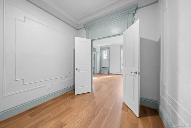 a view of hallway with wooden floor