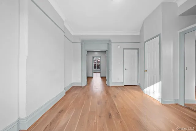 a view of an empty room and wooden floor