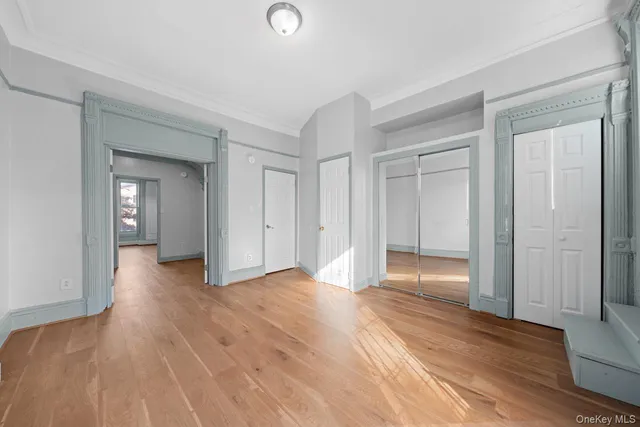 a view of empty room with wooden floor