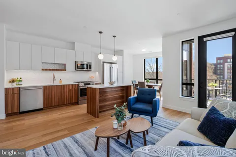 a living room with furniture and kitchen view