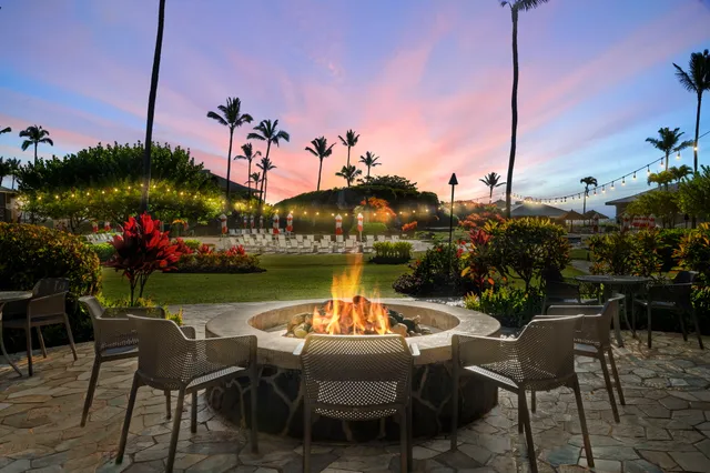 a table and chairs sitting in the middle of a lake