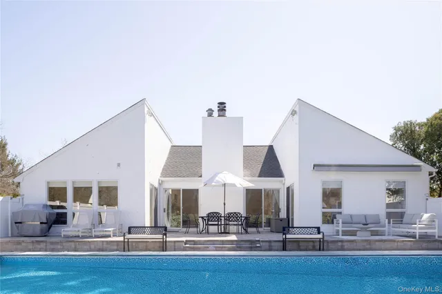 a dinning area with glass top table and chairs