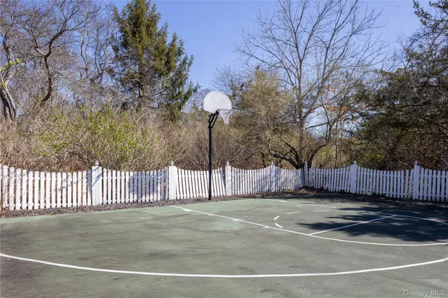 a view of a yard with wooden fence