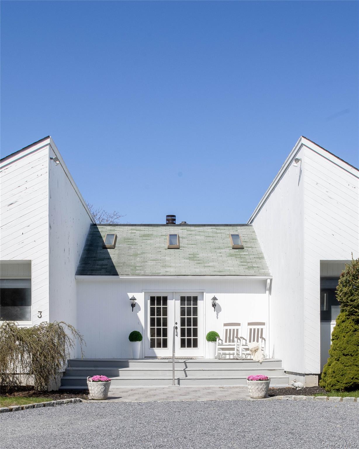 3 Clay Pit Road Remsenburg, NY 11960 - Photo 20 of 20 a front view of a house with a garage